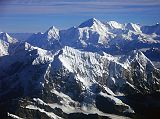 12 Kathmandu Mountain Flight 07-4 Cho Oyu Above Numbur and Khatang With Nangpa La and Nangpai Gosum I Cho Oyu (8201m) dominates the view from the Kathmandu Mountain Flight as the plane leaves the Rolwaling area. The closest mountain is Numbur (6959m) on the left connected by a ridge to Khatang (6853m) on the right. The Nangpa La pass between Tibet and Nepal is in the upper left, and the pointed peak to the left of Cho Oyu is Nangpai Gosum I (7351m, also called Cho Aui or Pasang Lhamu Chuli).